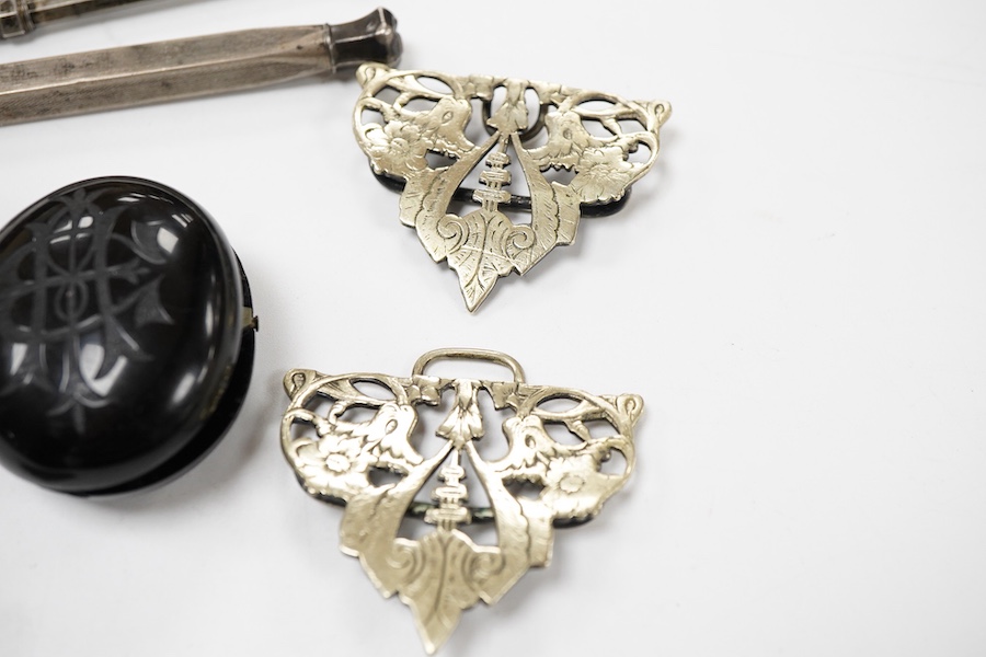 A group of jewellery, comprising: a locket, possibly in jet or bog oak, bearing the initials CIM, the interior with two compartments, length 4.6cm, design registration mark for circa 1861, maker's mark; three mechanical
